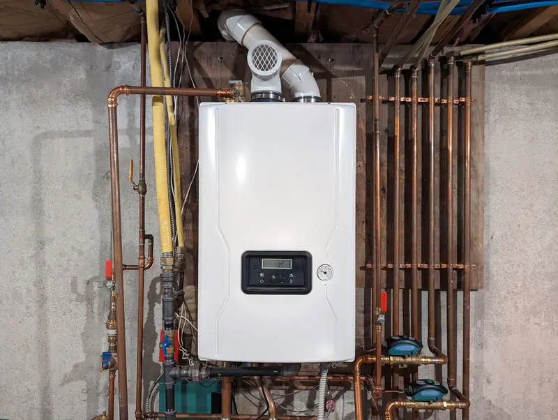 A Tankless water heater in the basement of a home